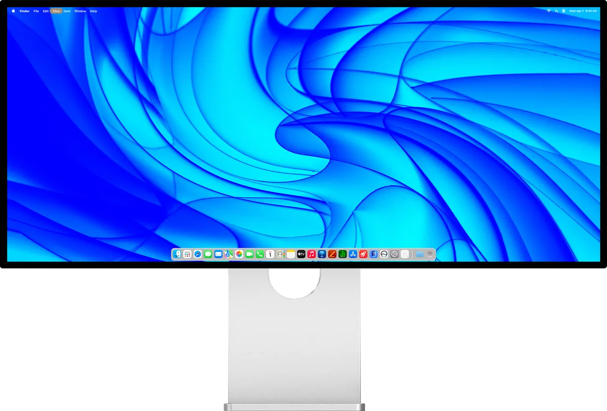 Ultrawide-Monitor Kuycon W34KB in der Vorderansicht auf seinem Aluminium-Standfuß, mit dem macOS-Schreibtisch auf einem blauen Hintergrundbild